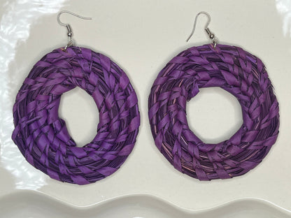 Purple braided hoop earrings on a white background