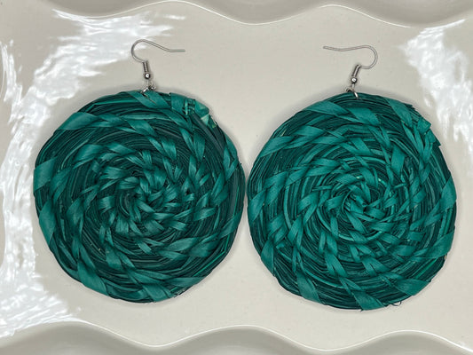Pair of teal circular earrings on a white background