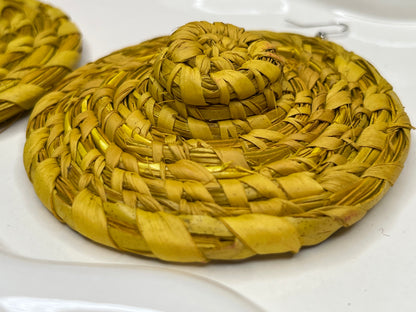 Yellow woven earrings  on a white surface